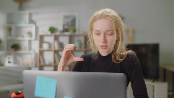 Young Beautiful Woman Learning Sign Language at Home in Living Room Using Online Lesson