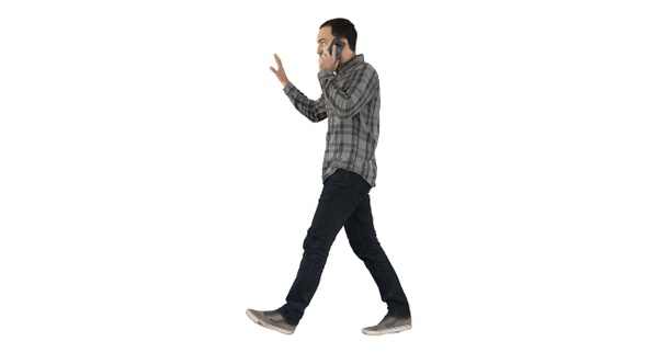 Man talking on phone walking and making gestures on white