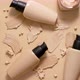 Bottles of Makeup Foundation and Samples on Beige Background - VideoHive Item for Sale