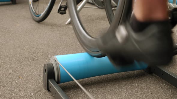 Training on exercise bicycle. Cyclist warming up on track bicycle before race competition