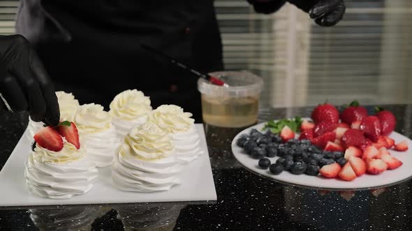 Pastry Chef Decorates Anna Pavlova's Cakes with Fresh Fruiets and Mint Leaves