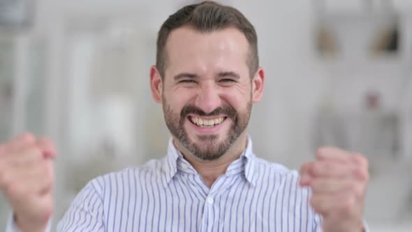 Portrait of Ambitious Young Man Celebrating Success