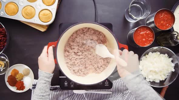 Time lapse. Step by step. Top view. Cooking turkey chili in enameled cast iron covered dutch oven.