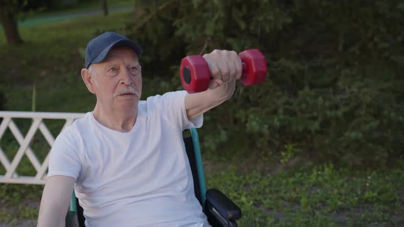 Its a Challenge for Older Man to Do Exercises with Dumbbells