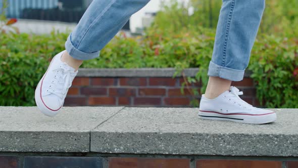 Close up of girl’s legs walking in the city 