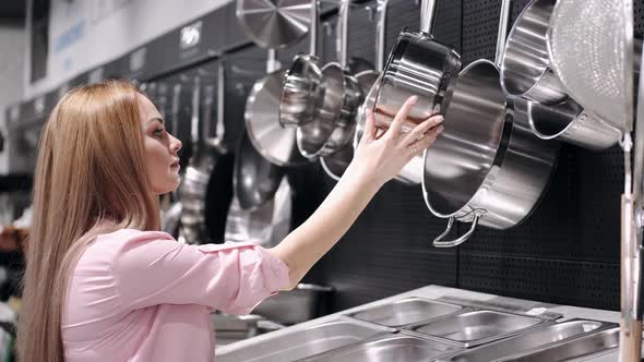 The Beautiful Woman Is Checking the Stainless Steel Tableware