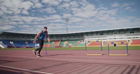 Sportsman Practicing Long Jump on Arena