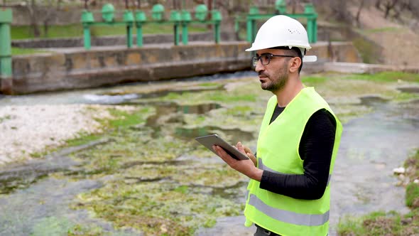 Engineer Investigates in Electric Water Dam