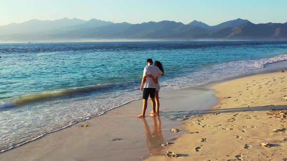 Fun couple on honeymoon vacation spend quality time on beach on paradise white sand background 4K