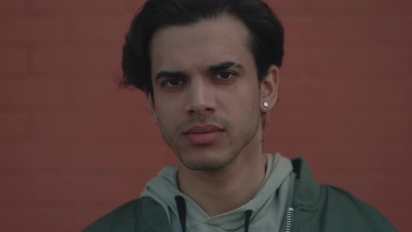 Portrait of Man in Stylish Wear Posing Near Brick Wall