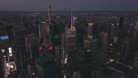 AERIAL: Manhattan Drone Flight at Night with Glowing City Light in New York City 