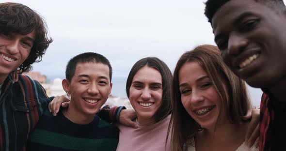 Group of young multiracial friends smiling on camera