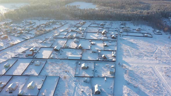 A Small Village in the Middle of a Pine Forest in Winter After Snowfall on a Bright Sunny Day