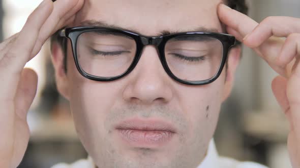 Close Up of Man in Glasses with Headache and Stress