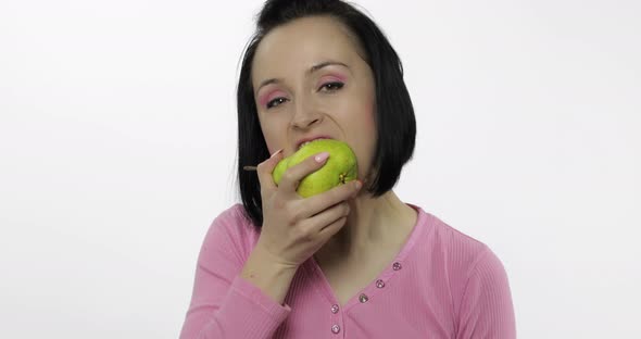 Woman Eating Fresh Pear and Says Yum. Girl Takes First Bite and Say Wanna Bite