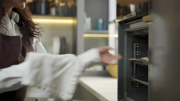 Young Couple Smells Fresh Bakery Taken Out of Oven at Home