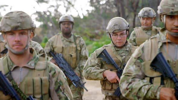 Front view of mixed-race military soldiers rifle training in fields during military training 4k