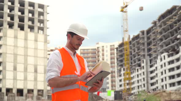 Architect or Engineer Working Browsing Building Project of Construction Site with Tablet