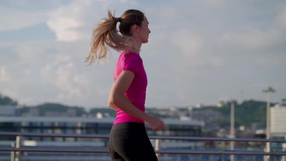 Healthy Lifestyle and Sport Activities of City Dwellers Young Woman is Jogging in Morning