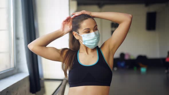 Portrait of Fit Woman in a Protective Face Mask