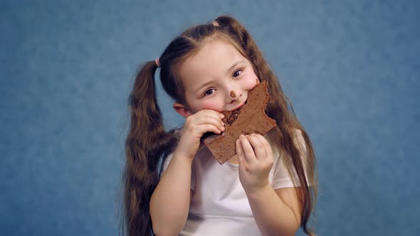 Portrait of a Little Girl Eating Chocolate