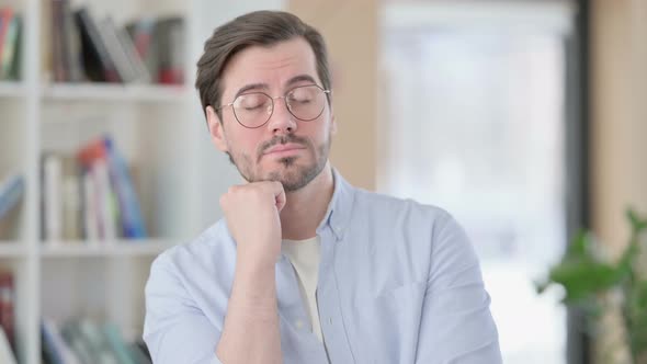 Portrait of Sleepy Man in Glasses Taking Nap