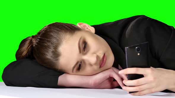 Tired Working Answering the Phone in Her Office. Green Screen