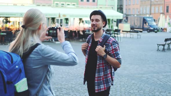 Couple of Tourists Making Photos with Photo Camera on Historical Market Square