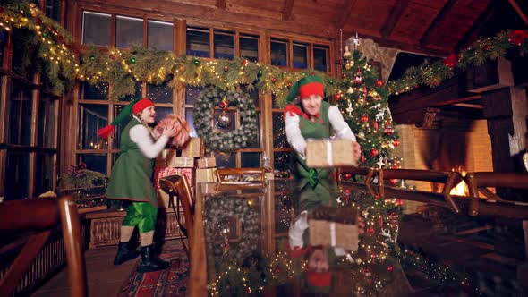 Joyful elves with gift boxes