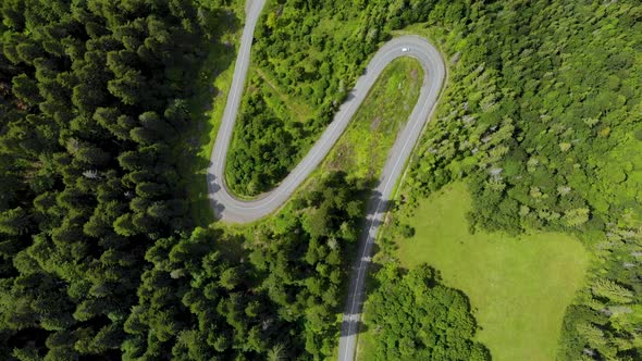 Aerial Car Drive on Winding S-Shaped Road in Italy