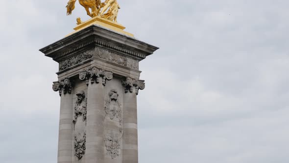 Alexandre III bridge golden statues column detail in Paris France slow tilt 4K 2160p UltraHD tilt fo