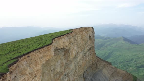 Drone Flying Along the Edge of High Cliff