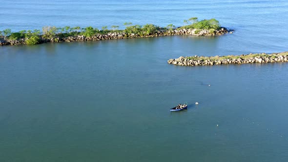 Fisherman in Soco River mouth with fishing criminal method, Dominican Republic. Aerial drone view