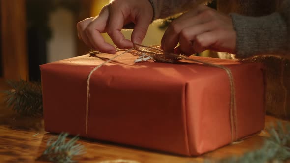 Woman Decorating Box with Christmas Present