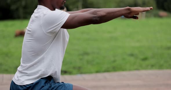 African American Man Limberingup and Stretching Legs After Running Jog Workout