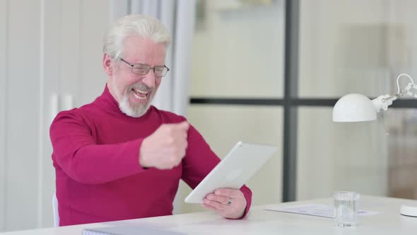 Successful Old Man Celebrating on Tablet at Work