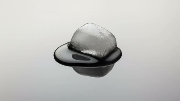 Melting Ice Cube on mirror.