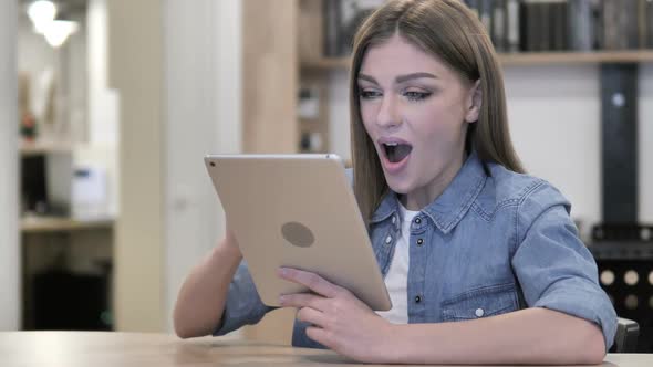 Excited Girl Celebrating Success While Using Tablet