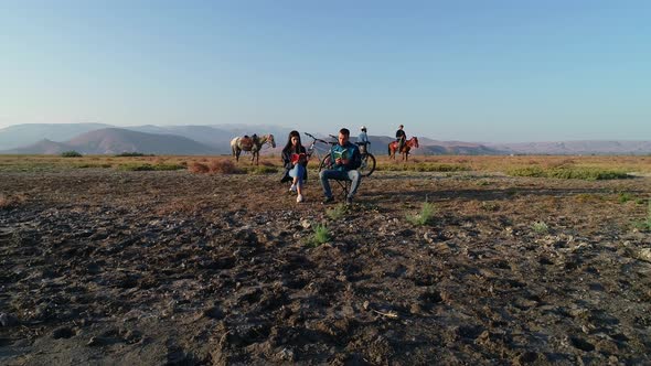 Couple Reading a Book and Horses in Nature