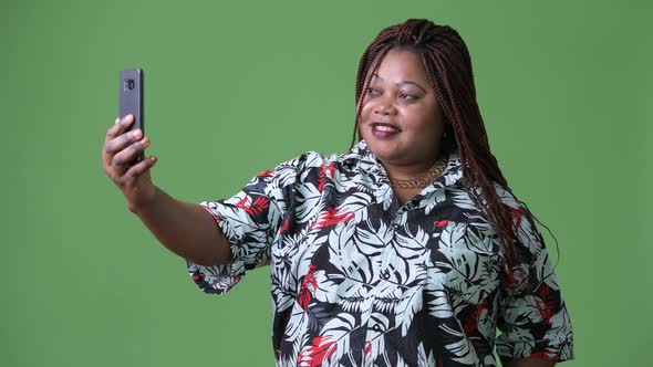 Overweight Beautiful African Woman Against Green Background