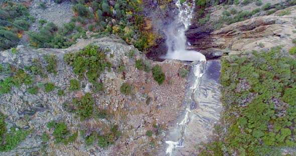 An Awesome Sight of a Waterfall Within Alpine Woodland.