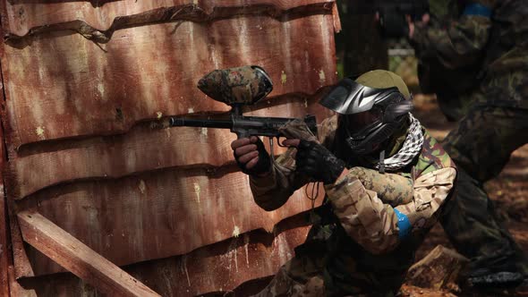 Paintball Sport Player Wearing Protective Mask Shooting