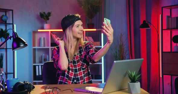 Blondie with Earring in Nose Making Selfie on Smartphone with Funny Faces at Home