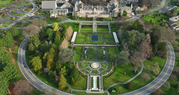 Huge English garden, fountain stone mansion estate. Aerial view in spring.