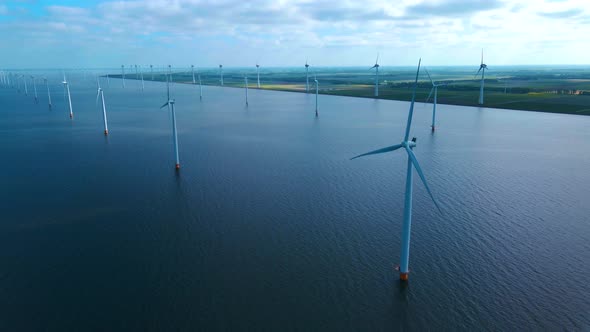 Offshore Windmill Park with Clouds and a Blue Sky Windmill Park in the Ocean Drone Aerial View with