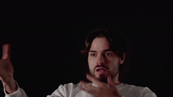 Trendy Young Man frightened gesture, scared expression, close, black background