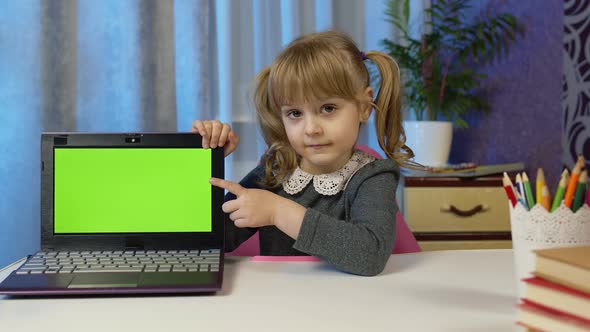Child Girl with Laptop Looking on Green Screen at Home Online Distance Lessons Children Education