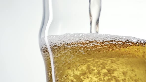 Foaming Beer is Poured Into the Glass in Slow Motion