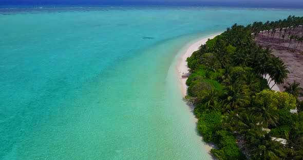 Luxury flying travel shot of a summer white paradise sand beach and aqua turquoise water background 