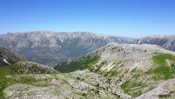 Alpine meadows and mountain range in Llogara National Park, Albania. Maja e Cika peak on background.